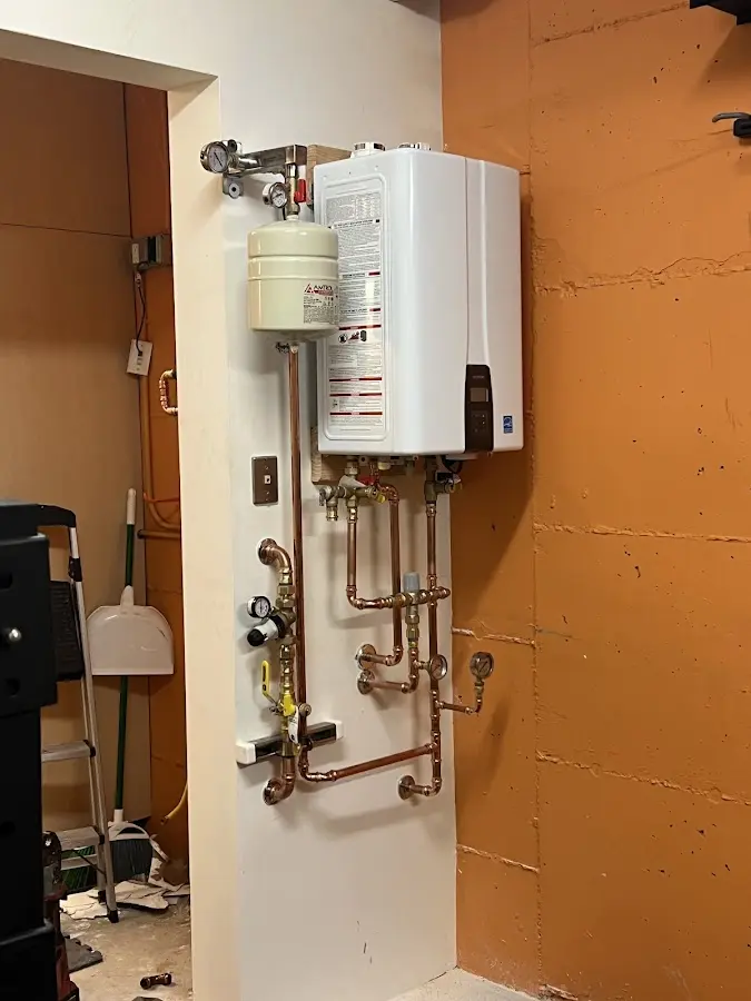 Plumbing technician inspecting water heater connections in Highgrove